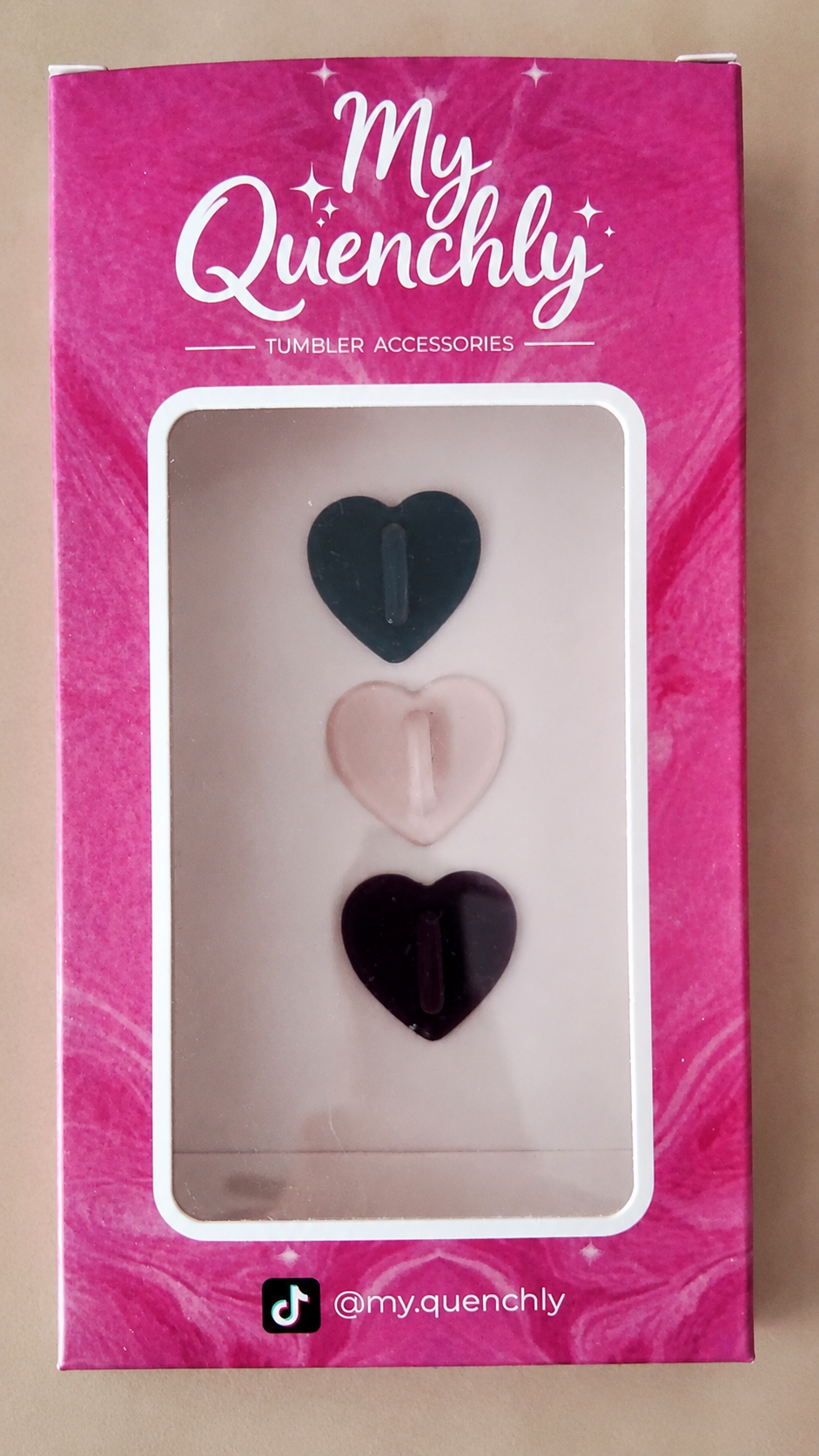 My Quenchly tumbler accessories packaging with heart-shaped designs on a pink background