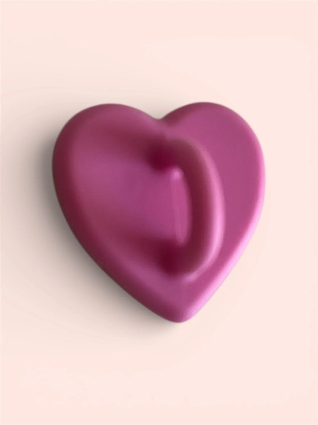 Smooth pink heart-shaped object on soft background