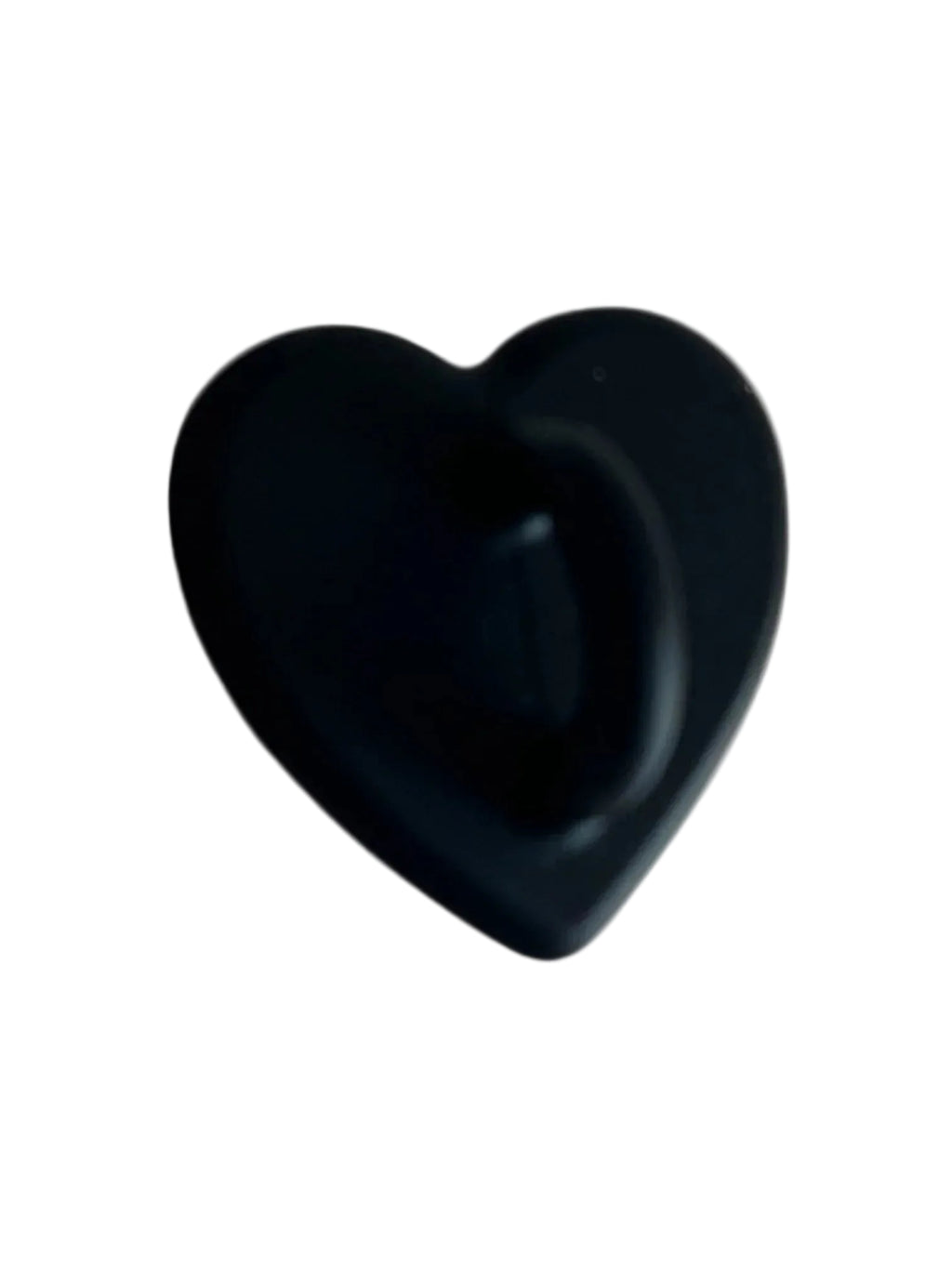 Black heart-shaped object with smooth matte finish on light background