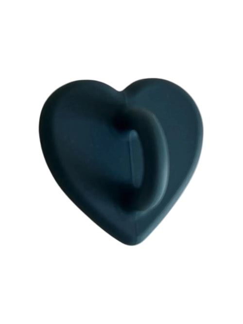 Dark teal heart-shaped silicone object with textured grip, minimalist design on light background