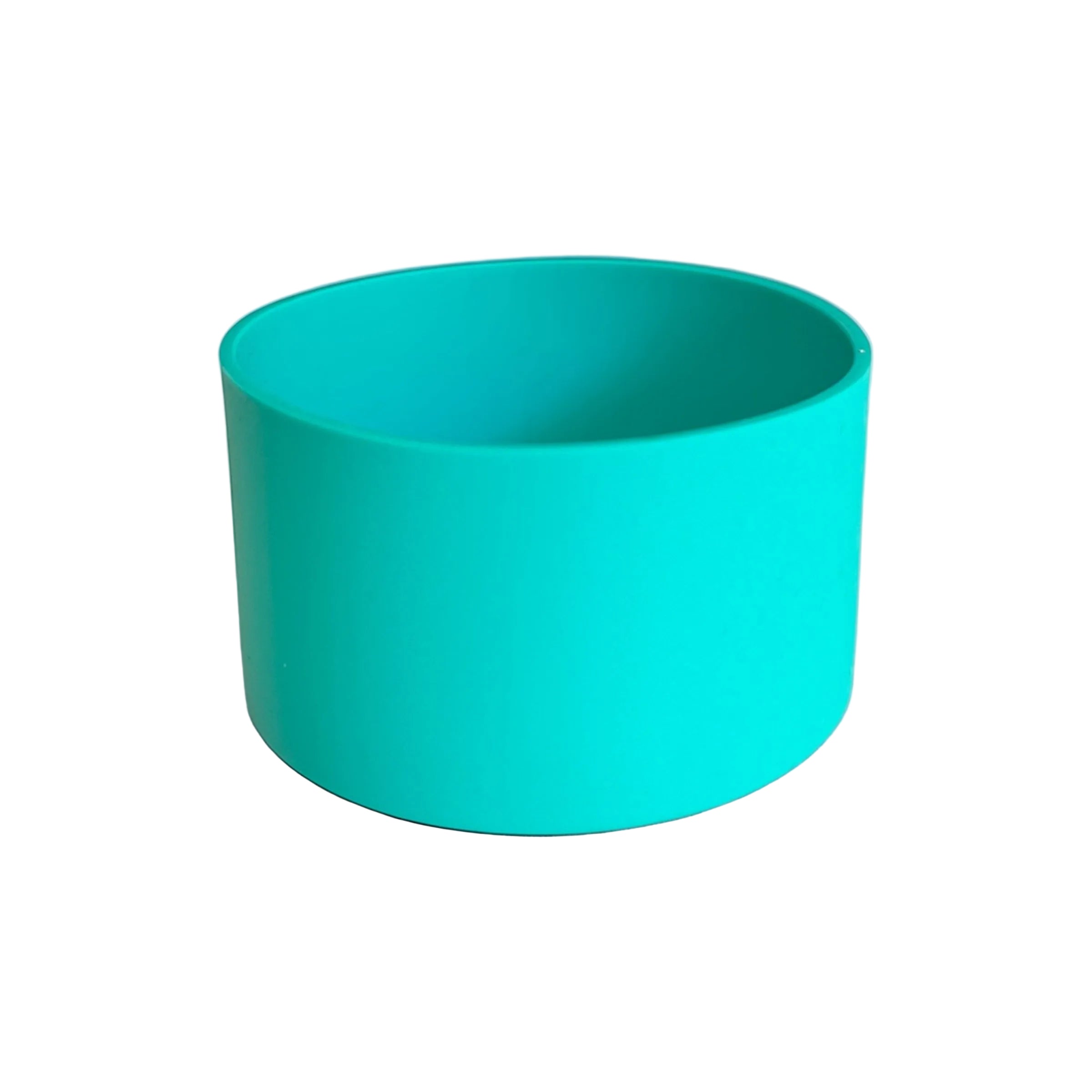 Turquoise bowl on a textured surface with a light gray background