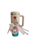 Travel mug with decorative keychain on a white background