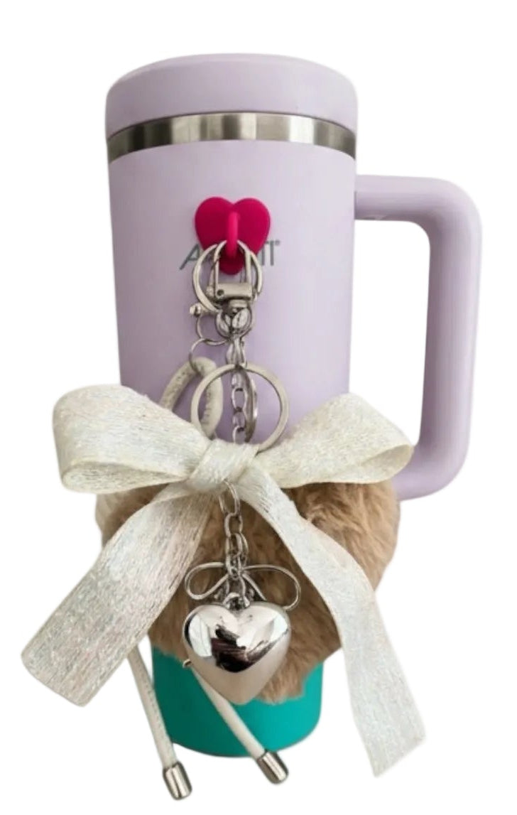 Purple mug with a keychain featuring a heart and a small bag on a white background
